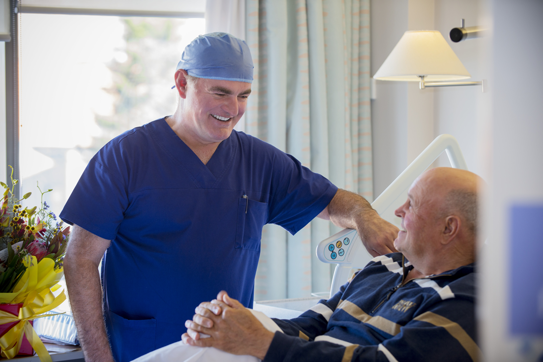 Cardiologist consults bedside with a patient
