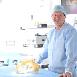 Professor Ross Crawford stands in an operating theatre