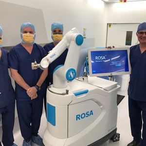 Surgeons stand next to a immer Biomet Knee platform