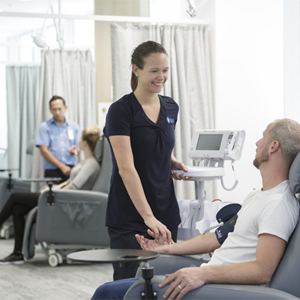 Female nurse with male patient in treatment centre