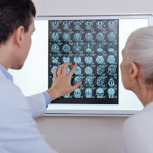 Doctor and patient look at brain scans