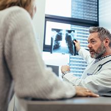 Doctor and partient look at an xray scan