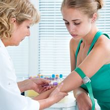 A pathologist takes a blood sample