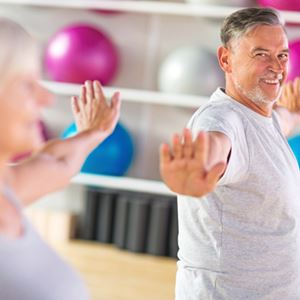 Elderly couple exercising in gym